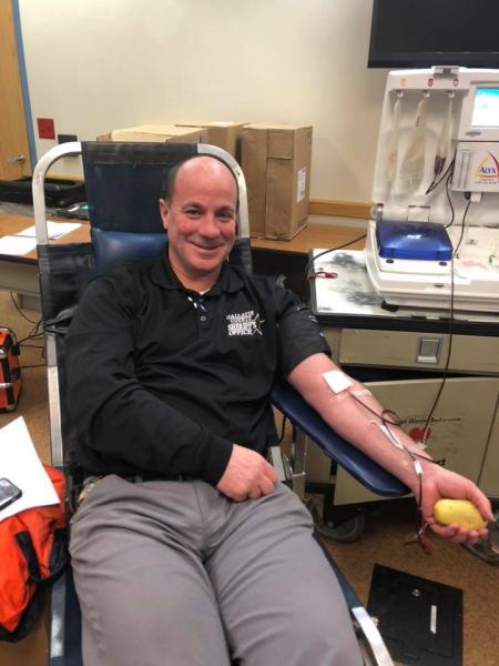 gallatin county sheriff dan springer donates blood at a blood drive